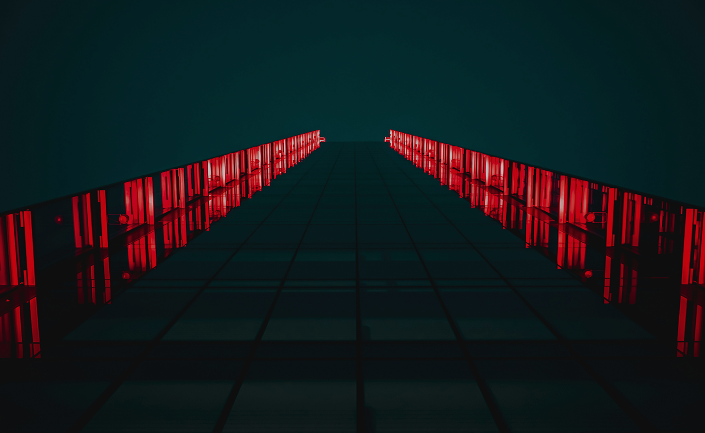A dark corridor illuminated by red light